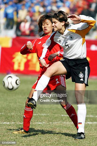 China's Han Duan and Germany's Annike Krahn battle for the ball during the Four-Nation's Women's Championships at Guangzhou, China, January 28, 2007....