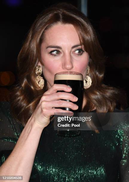 Catherine, Duchess of Cambridge drinks a Guinness at a reception hosted by the British Ambassador to Ireland Robin Barnett at the Guinness...