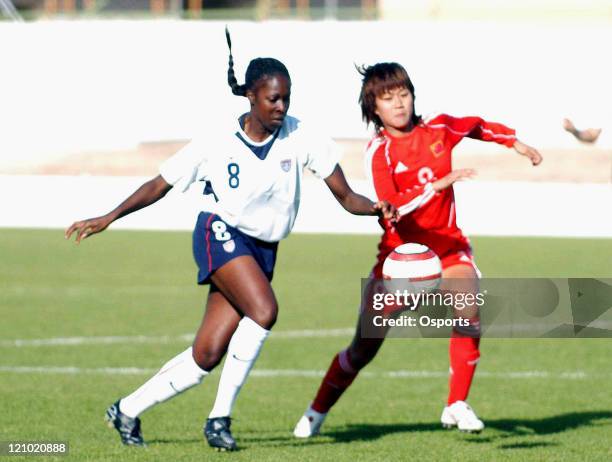 S Tina Ellertson and China's Han Duan in action during the group B Algarve Cup match between the USA and China at Municipal Stadium in Silves,...