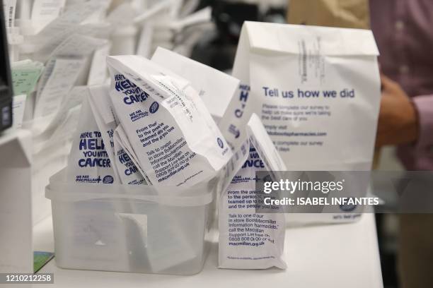 Made-up packages of prescription medication, is pictured on the counter inside a Boots pharmacy, before collection by Bikeworks cycling instructor...