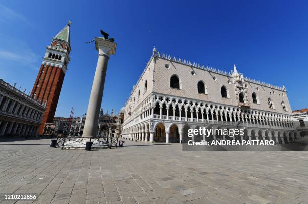 This picture taken on April 17 shows a general view of an empty St. Mark square and the Doge's Palace in Venice as the nation tries to curb the...