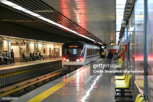 a metro train approaching a modern subway station in tehran, iran - tehran stock pictures, royalty-free photos & images