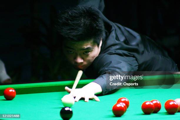 Ding Junhui of China considers his shot options during the Men's Snooker Team match between China and Macau at the 15th Asian Games in Doha, Qatar on...