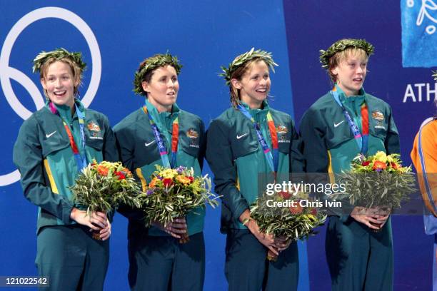 Alice Mills, Lisbeth Lenton, Petria Thomas and Jodie Henry of Australia win gold medal and set a new WR in the 4x100m Freestyle Relay Final in...