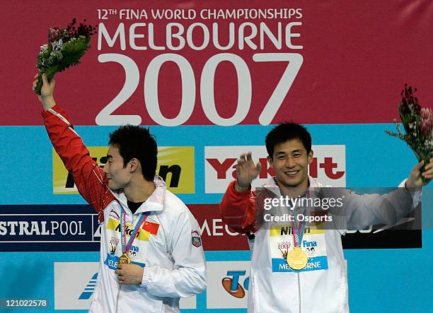 China's Qin Kai and Wang Feng celebrate after winning the men's 3m synchro springboard diving at the 12th FINA World Swimming Championships at the...