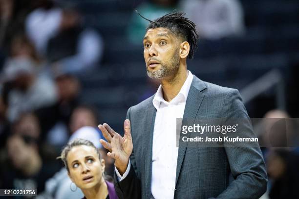 Assistant coach Tim Duncan of the San Antonio Spurs reacts during the third quarter of the game against the Charlotte Hornets at Spectrum Center on...
