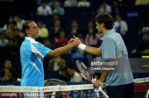 Roger Federer and David Nalbandian shake hands after their first round match at the Tennis Masters Cup in Shanghai, China on November 12, 2006....