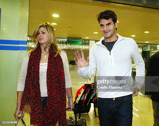 Switzerland's Roger Federer and his girlfriend Mirka Vavrinec arrive at the Shanghai Pudong International Airport on November 6, 2006 to attend the...