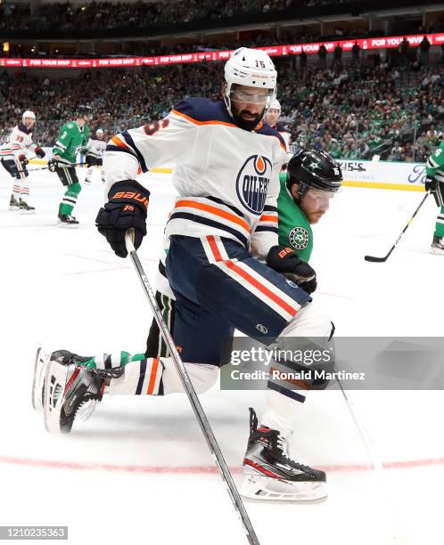 Jujhar Khaira of the Edmonton Oilers skates the puck against Joe Pavelski of the Dallas Stars in the second period at American Airlines Center on...