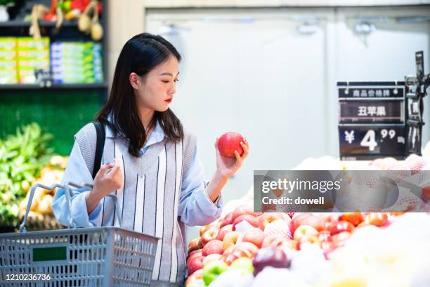 young female buy fruit in supermarket - asian woman shopping grocery stock pictures, royalty-free photos & images