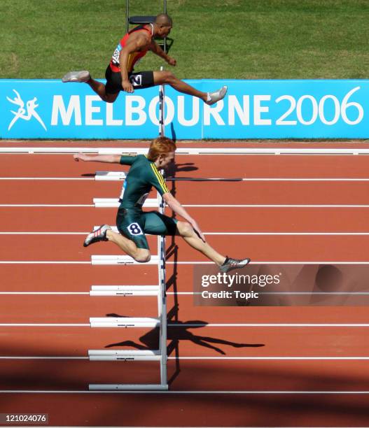 Australia's Brendan Cole and South Africa's Pieter De Villiers compete in the 400m Men's Hurdles during the Commonwealth Games at the Melbourne...