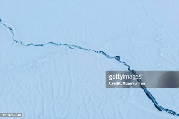 cracks in ice lake - crevasse fotografías e imágenes de stock