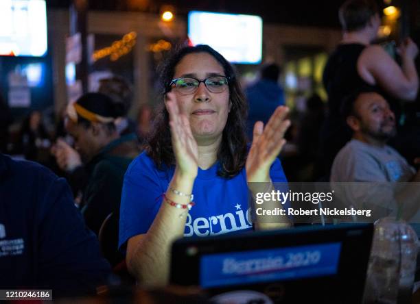 Campaign volunteers for Democratic presidential candidate Sen. Bernie Sanders celebrate election headlines at an election watch party on Super...