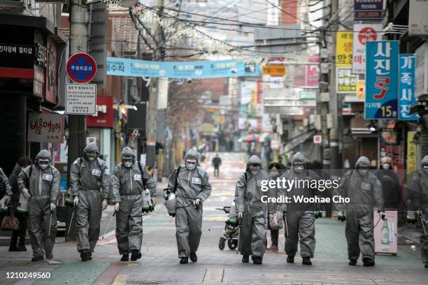 South Korean soldiers, in protective gear, disinfect the Eunpyeong district against the coronavirus on March 04, 2020 in Seoul, South Korea. The...