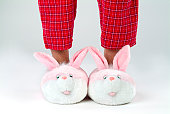 Man's legs in bunny slippers