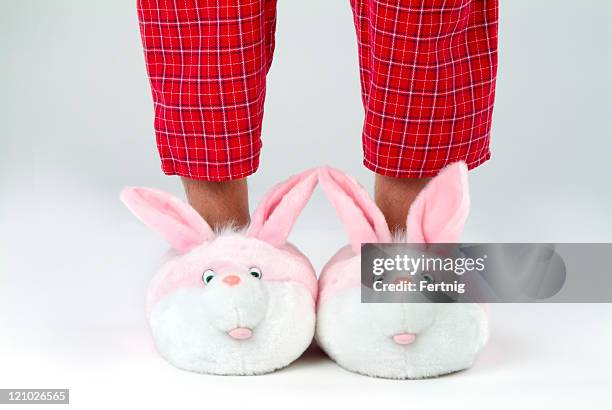 man's legs in bunny slippers - funny slipper stock pictures, royalty-free photos & images