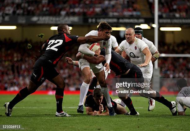 Toby Flood of England is tackled by Aled Brew of Wales during the rugby union international friendly match between Wales and England at the...