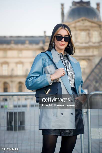 Brittany Xavier wearing Louis Vuitton blue jacket, silver shirt, black leather skirt and black shoes outside the Louis Vuitton show during Paris...