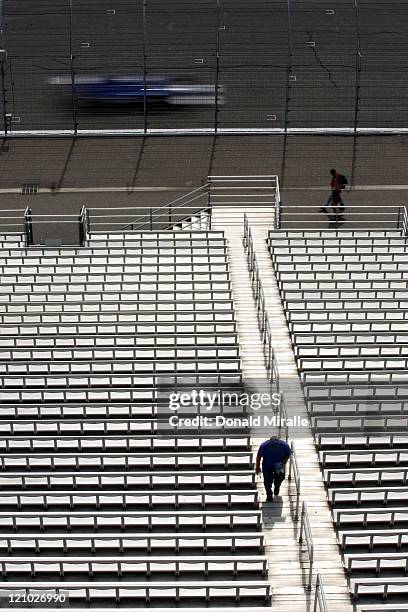 Fans walk through empty stands during practice for the IZOD IndyCar Series MoveThatBlock.com Indy 225 at New Hampshire Motor Speedway on August 13,...
