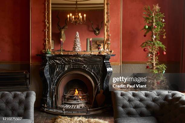 elegant red and gilded living room with marble fireplace and gold mirror. - imperfection stock pictures, royalty-free photos & images