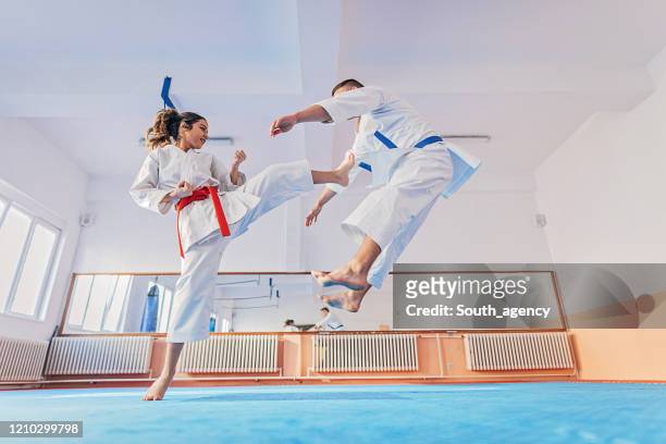 teenagers practicing karate together - girl punching stock pictures, royalty-free photos & images