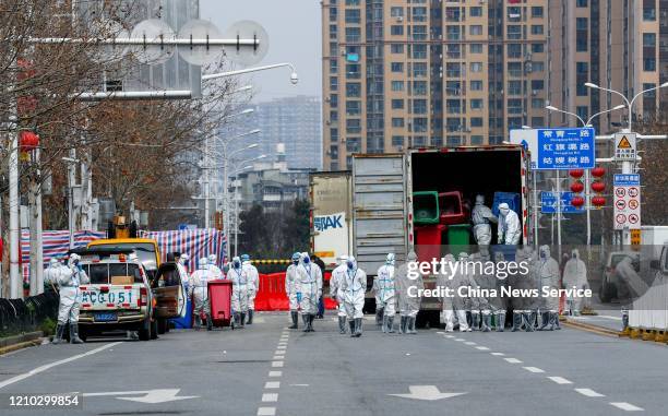 People wearing protective masks and suits do disinfection work at Huanan Wholesale Seafood Market on March 4, 2020 in Wuhan, Hubei Province of China....