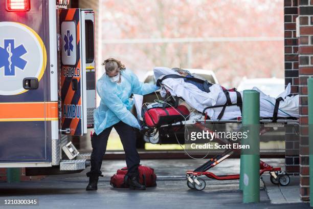 First responders load a patient into an ambulance from a nursing home where multiple people have contracted COID-19 on April 17, 2020 in Chelsea,...
