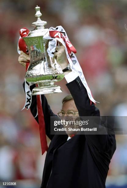 Alex Ferguson the manager of Manchester United celebrates with the trophy after the AXA FA Cup Final match against Newcastle United played at Wembley...