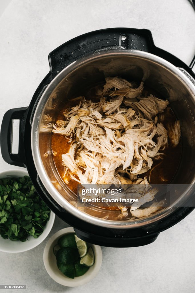 Shredded spiced chicken inside of an Multi Cooker
