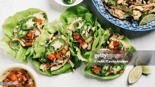 cilantro lime shredded chicken lettuce wrapped tacos dinner - split chicken stock pictures, royalty-free photos & images