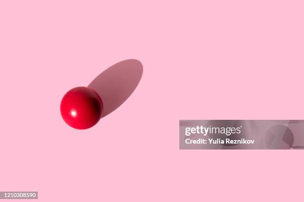 red billiard ball on the pink background - billiard ball game stock pictures, royalty-free photos & images