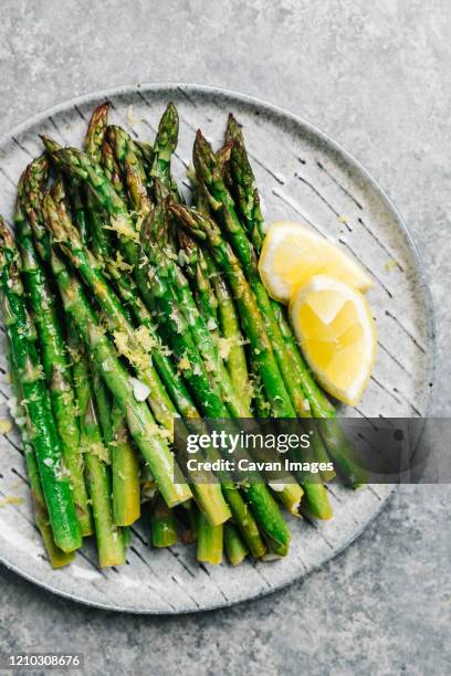 platter of lemon garlic asparagus - asparagus stock pictures, royalty-free photos & images