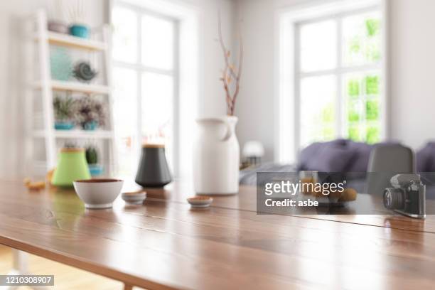 wooden table top with blur of modern living room interior - table stock pictures, royalty-free photos & images
