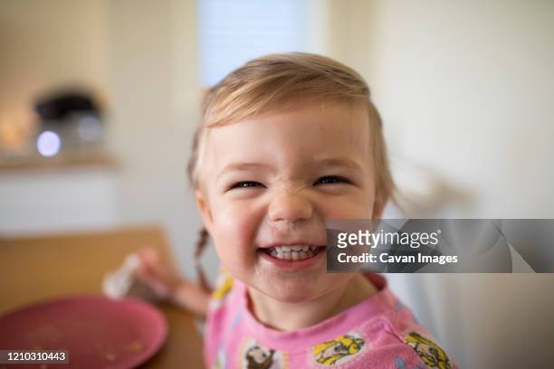 portrait of cute girl smiling at mealtime. - toughness stock-fotos und bilder