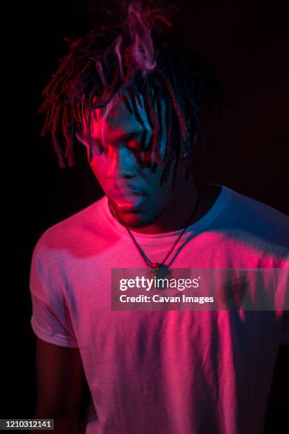 portraits of beautiful african young man under blu and red lights - all hip hop models stock pictures, royalty-free photos & images