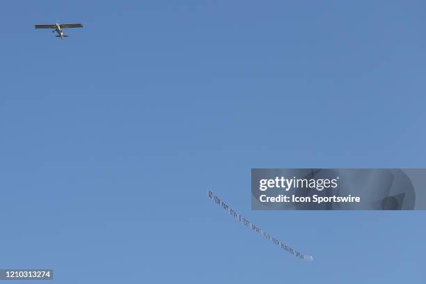 Plane carries a banner reading DO YOUR PART STAY 6 FEET APART HELP KEEP BEACHES OPEN over crowded the beaches in its first open hour on April 17,...