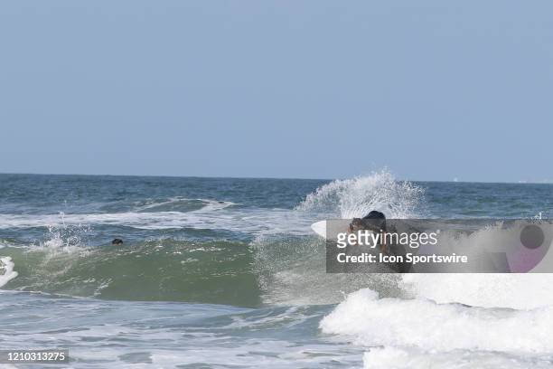 Surfer rides a wave during the beaches first open hour on April 17, 2020 in Jacksonville Beach, Fl. Jacksonville Mayor Lenny Curry opened the beaches...
