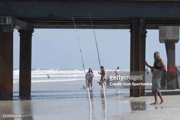 Man fishes from the shore during the beaches first open hour on April 17, 2020 in Jacksonville Beach, Fl. Jacksonville Mayor Lenny Curry opened the...