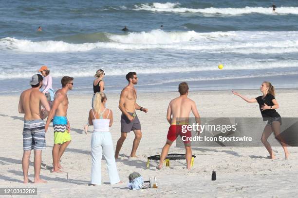 People play a game of Spike Ball on the beach in its first open hour on April 17, 2020 in Jacksonville Beach, Fl. Jacksonville Mayor Lenny Curry...