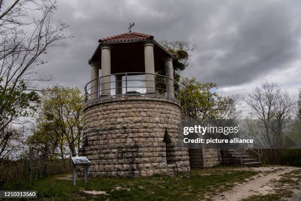 April 2020, Brandenburg, Rüdersdorf: Clouds pass over the bell tower in the Rüdersdorf Museum Park. The 17ha large museum park offers stories from...