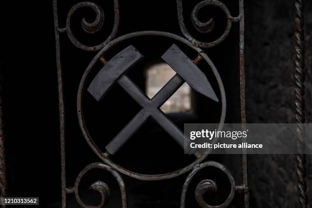 April 2020, Brandenburg, Rüdersdorf: The emblem of mining can be seen in front of a tunnel in the Rüdersdorf Museum Park. The 17ha large museum park...