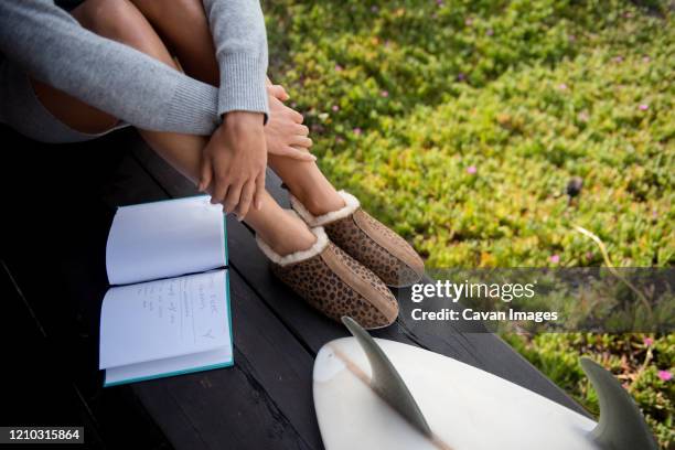 a cozy woman reflects in her journal - water margin stock pictures, royalty-free photos & images