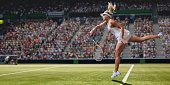 Professional Female Tennis Player Serving On Grass Court During Match
