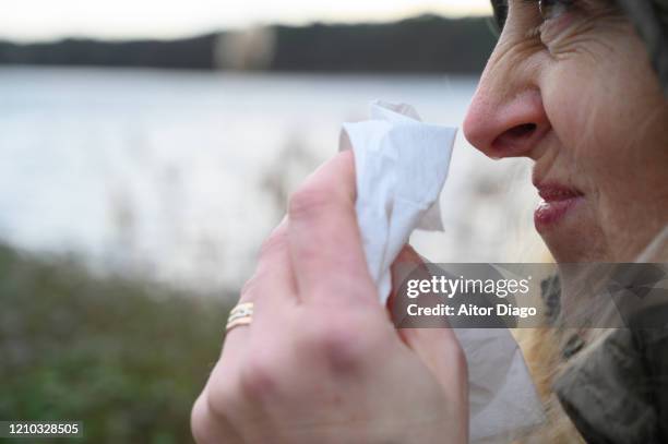 cold or allergy woman in winter in the shea with a tissue. - mucus stock pictures, royalty-free photos & images