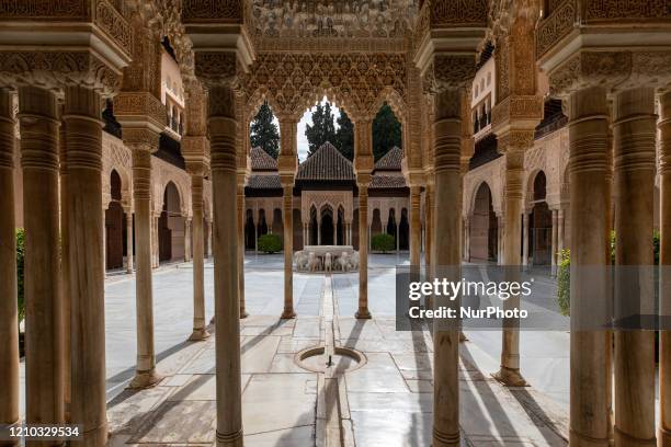 The Court of the Lions, with the Fountain of the Lions, without people at the Alhambra on April 17, 2020 in Granada, Spain. The Alhambra is the most...
