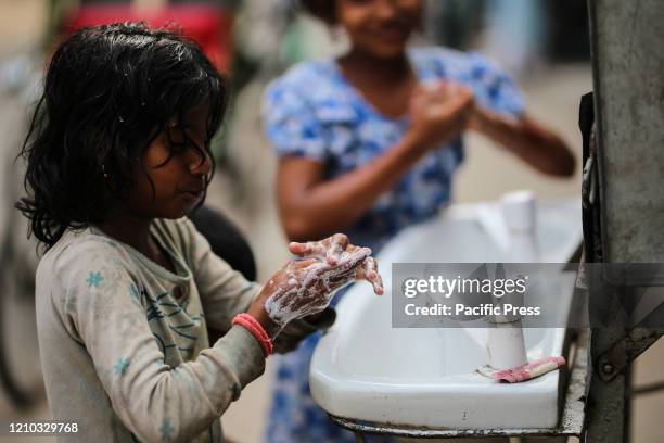 Children are washing hands on the basin that was installed by the dhaka city corporation to the different streets that are very crowded. With new 341...