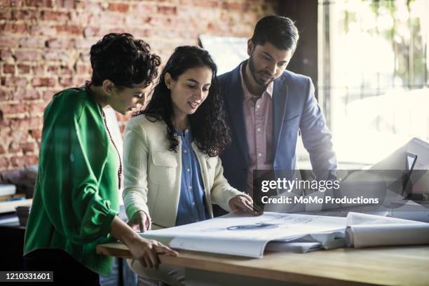 business colleagues discussing architecture project in office - asian architect 40 imagens e fotografias de stock