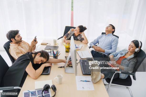 coffee break time business team sleeping at  in conference room during meeting office desk. they re overworked and fell asleep creative casual man sleeping at his working place - boring meeting stock pictures, royalty-free photos & images