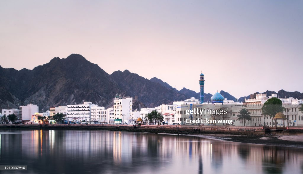 High Angle View Of Buildings And Mountains Against Sky - stock photo Photo taken in Muscat, Oman