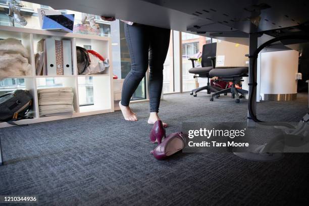 feet and shoes under desk - hallux valgus stock pictures, royalty-free photos & images